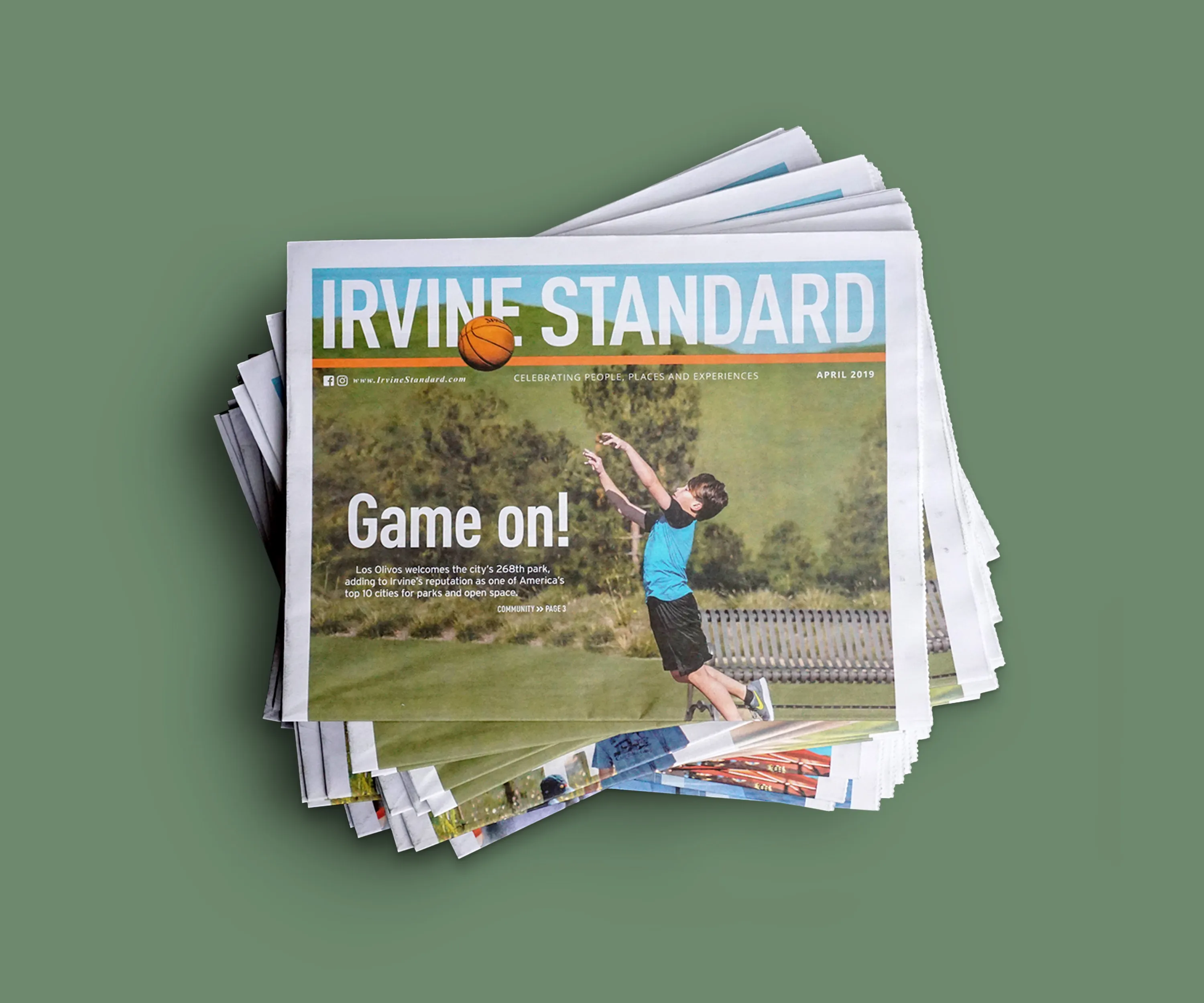 Stack of Irvine Standard papers with a "Game on!" sports cover.