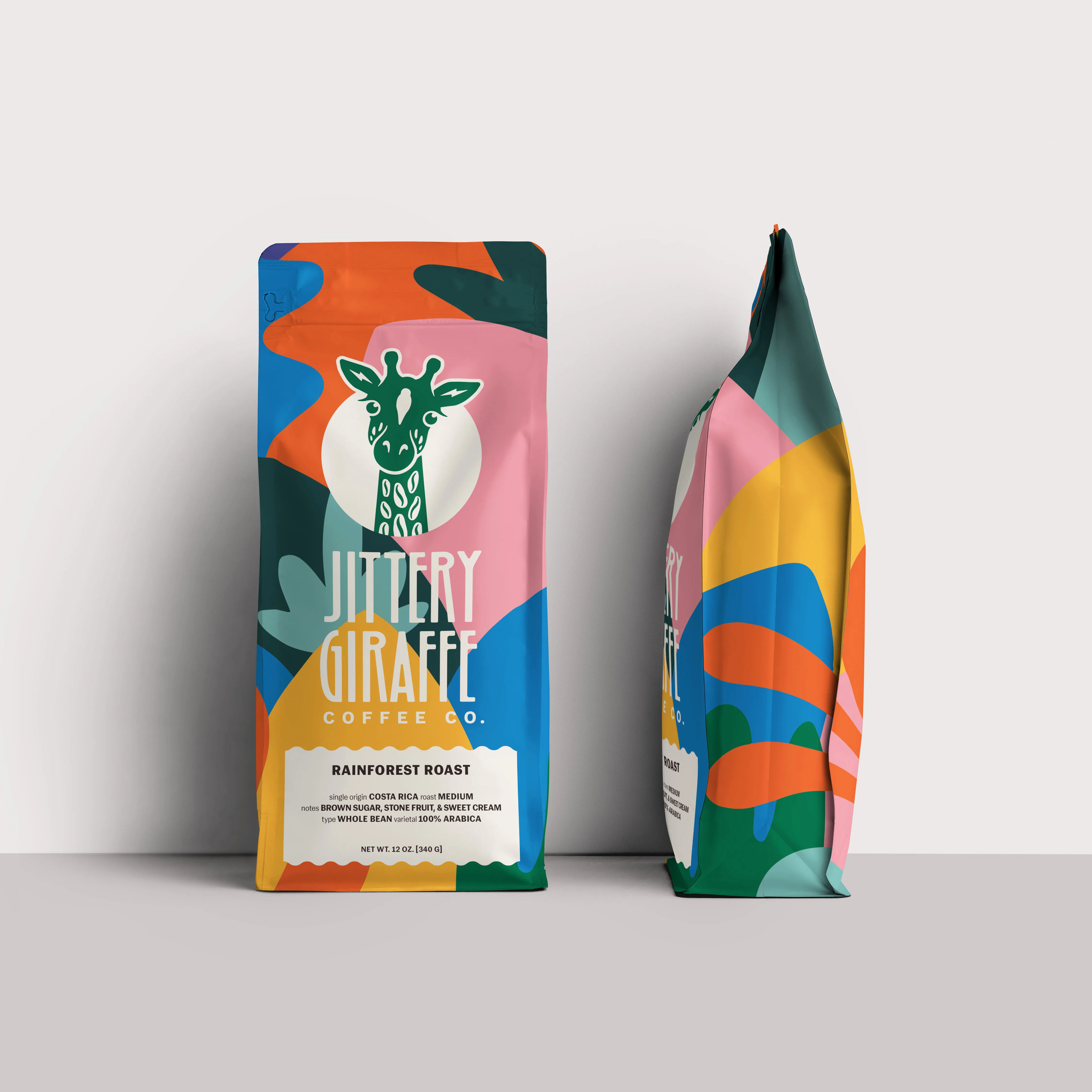 Two Jittery Giraffe coffee bags in bold jungle-pattern packaging.